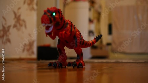 A toy dinosaur walks and makes sounds