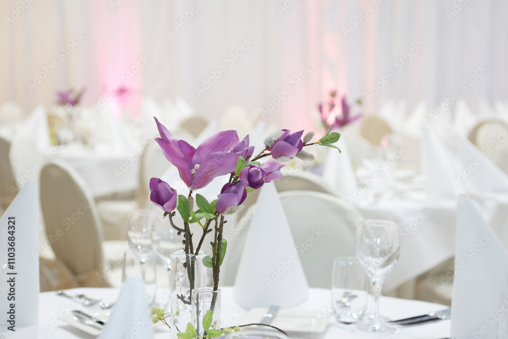 Elegant dining setup featuring floral arrangements for a special event in a beautifully decorated venue