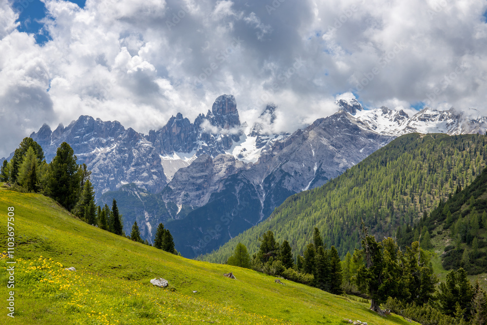 Fototapeta premium Dolomites mountains nasty weather in autumn with dark cloudy sky before the storm. Black clouds on the sky above the mountain rocky summits and peaks, stormy weather in the Dolomiti Alps, Italy. Extre