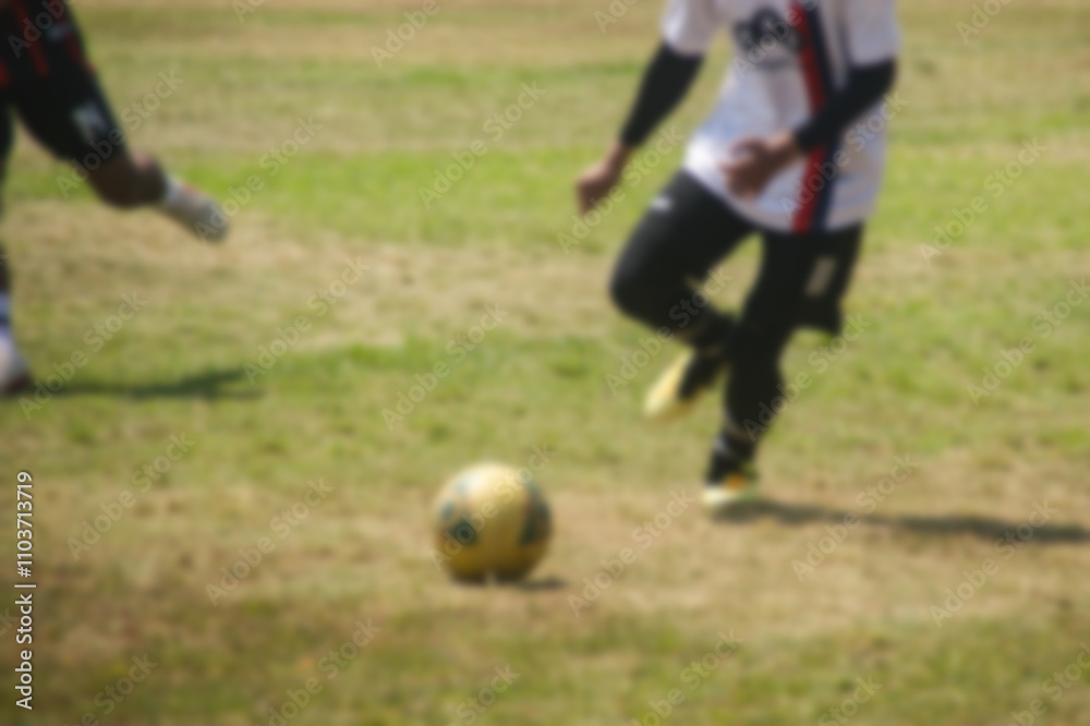 Obraz premium blurry image of amateur soccer players in action outdoor match