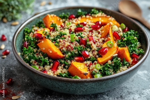 Salad of Hokkaido squash quinoa kale pomegranate green onion and toasted sunflower seeds Nutritious plant based dish