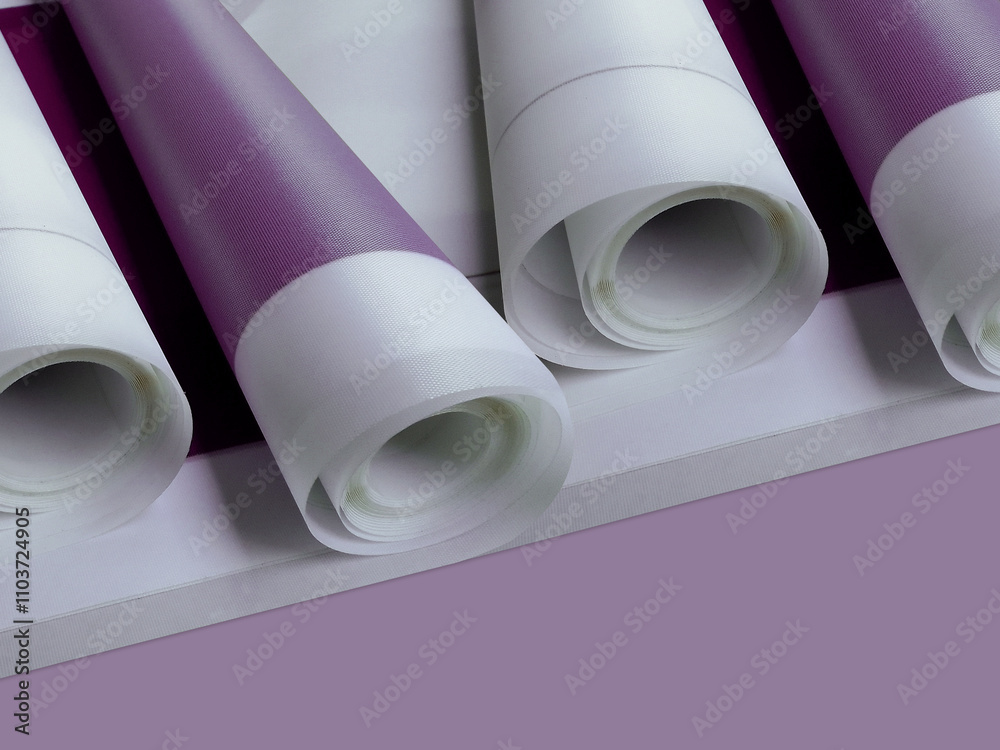 four rolled up banners on violet background. thin white fabric with purple print four rolled up banners on violet background. thin white fabric with purple print