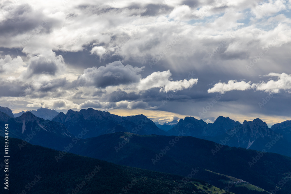 Dolomites mountains nasty weather in autumn with dark cloudy sky before the storm. Black clouds on the sky above the mountain rocky summits and peaks, stormy weather in the Dolomiti Alps, Italy Dolomites mountains nasty weather in autumn with dark cloudy sky before the storm. Black clouds on the sky above the mountain rocky summits and peaks, stormy weather in the Dolomiti Alps, Italy
