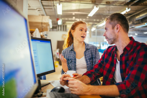 Photography Young man and woman using a computer while working in a printing press office