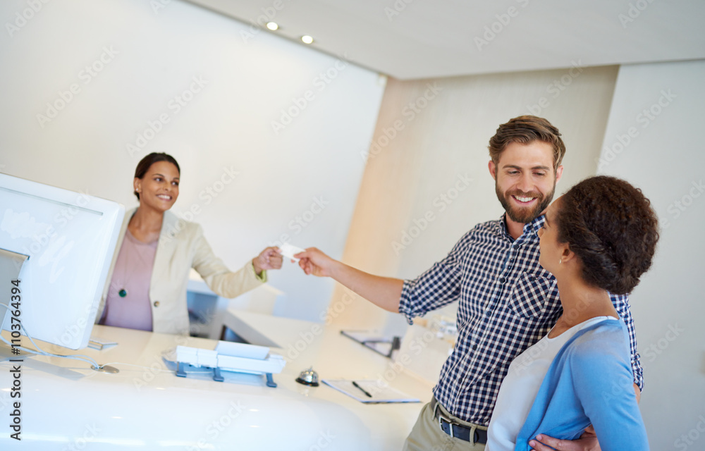 Fototapeta premium Reception desk, couple and card for check in, welcome and help with friendly service. Happy man, woman and people with smile, hospitality or holiday for reception or lodge vacation with room key