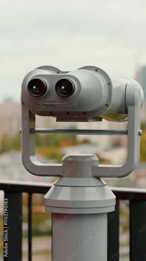 Cityscape in autumn season, tourist binocular in a observation deck, urban view on the city landscape, handheld. Cityscape in autumn season, tourist binocular in a observation deck, urban view on the city landscape, handheld.