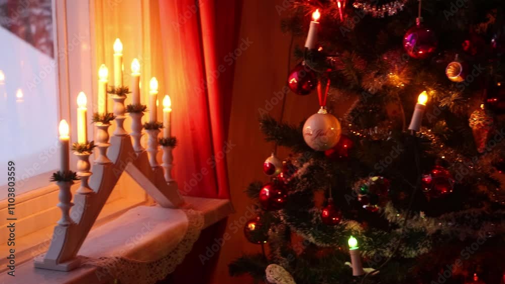 Decorated Christmas tree by the window with a electric candlestick Decorated Christmas tree by the window with a electric candlestick