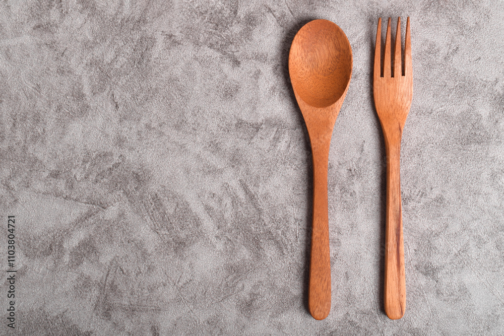 Top view of Wooden spoon and fork on table. A set of kitchen utensils Top view of Wooden spoon and fork on table. A set of kitchen utensils
