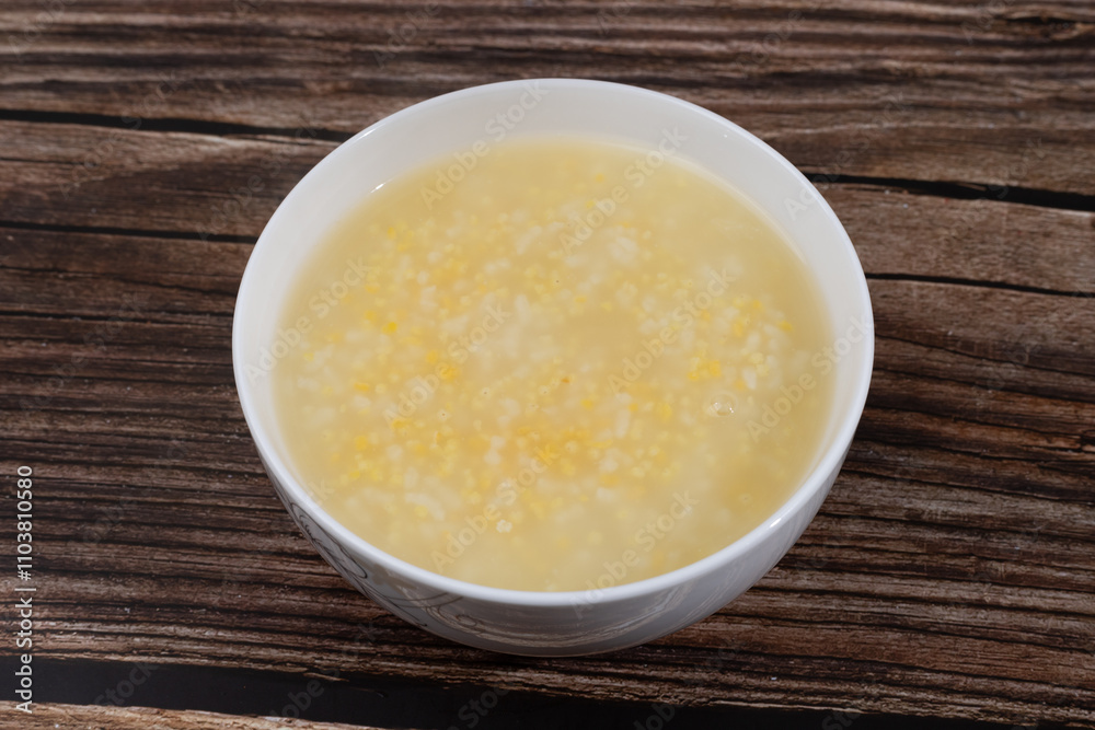 White rice, corn residue and yellow millet porridge in a small bowl White rice, corn residue and yellow millet porridge in a small bowl