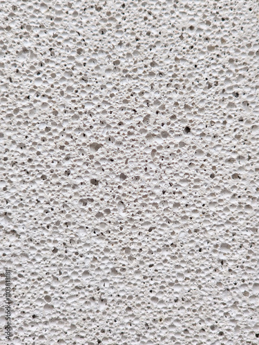 porous texture of pumice stone light gray color close-up background photo