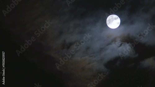 full moon shines brightly through the clouds in the night sky, on the right side