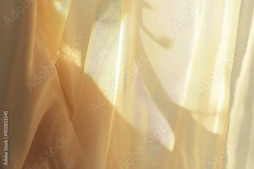 Golden sheer fabric with sunlight reflections.