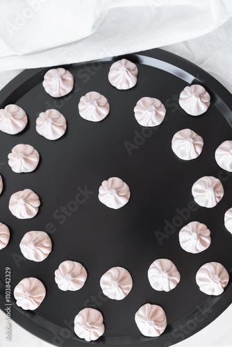 A close-up shot of khinkali magnets arranged on a black tray, emphasizing the delicate design and vibrant color palette, ideal for food art enthusiasts