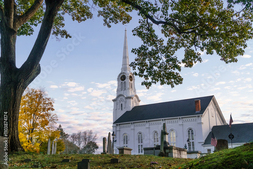 Andover, MA, US-October 22, 2024: South Church in Andover, Massachusetts - a classic white church with blue sky and old cemetery in foreground. photo