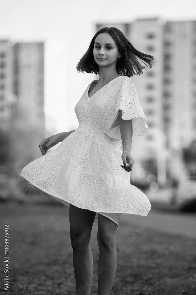Portrait of a young beautiful dark-haired girl in an urban environment. Black and white photo. Portrait of a young beautiful dark-haired girl in an urban environment. Black and white photo.