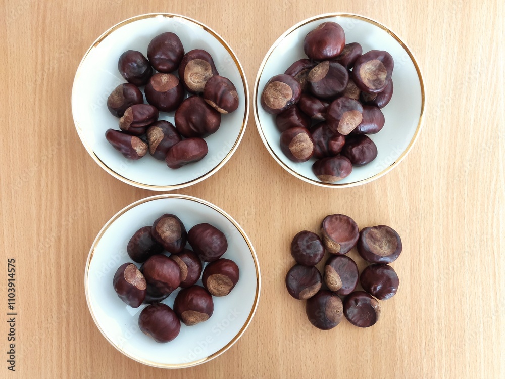 Fototapeta premium Shiny brown chestnuts on the table