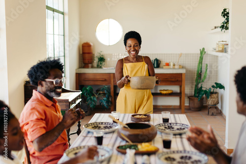 Brazilian family gathering for lunch in their kitchen photo