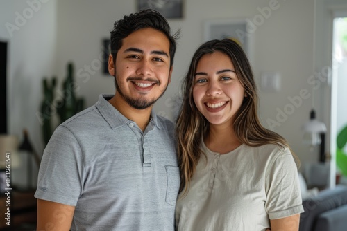 Portrait of a cheerful latino couple in their 20s wearing a breathable golf polo isolated on crisp minimalistic living room