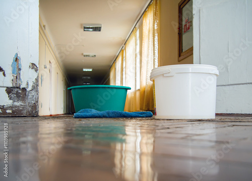 Containers for water flowing from the ceiling in the interior of an old building
