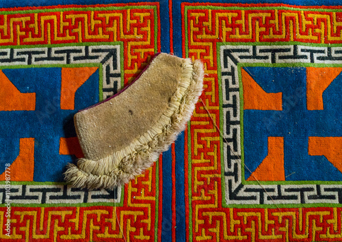 Yellow hat sect on a carpet with swastikas inside Bongya monastery, Qinghai province, Mosele, China