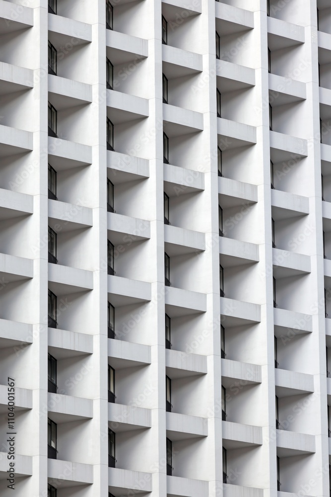 Modern high-rise facade with repeating geometric balconies creating a minimal and abstract urban pattern Modern high-rise facade with repeating geometric balconies creating a minimal and abstract urban pattern
