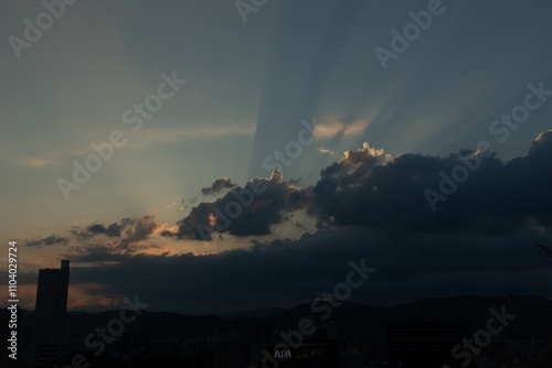 This is such a beautiful image of rays shooting out from the clouds. The sun is seen here beaming its light for all to see. A pretty clear blue sky is here.