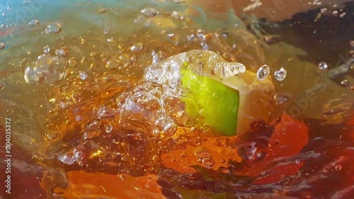 Lemon slices falling and splashing into iced tea, creating refreshing ripples and bubbles in slow motion 300fps