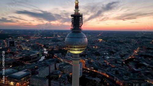 Aerial video shows a vibrant cityscape with a majestic tower famous places architectural landmarks TV Tower, Alexanderplatz at night. Berlin, Germany