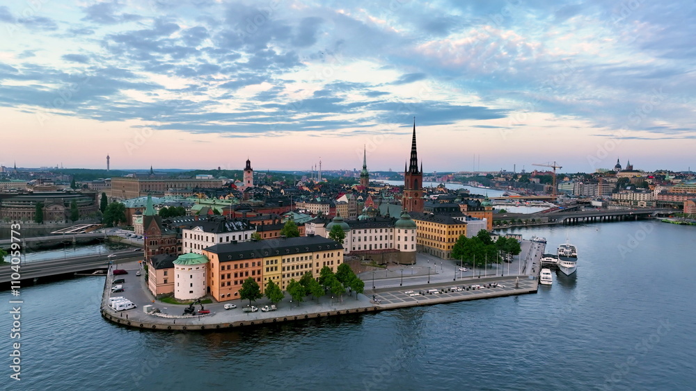 Obraz premium Aerial footage highlights a vibrant cityscape by serene water Riddarholmen Church, Stockholm City Hall. Sweden