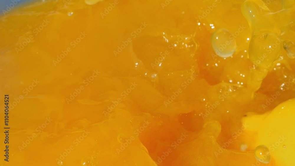 Lemon slices splashing into bright orange juice, creating vibrant waves in slow motion 300fps Lemon slices splashing into bright orange juice, creating vibrant waves in slow motion 300fps