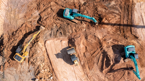 Aerial view road motor grader flatting dirt road surface, Motor grader road construction grader industrial machine construction site new road, Aerial view group excavator working on construction site. photo