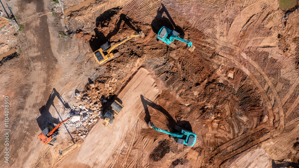 Aerial view road motor grader flatting dirt road surface, Motor grader road construction grader industrial machine construction site new road, Aerial view group excavator working on construction site.