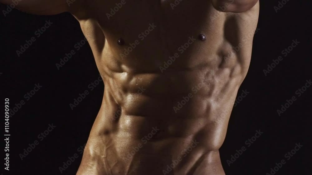 Strong male model, sexy sports athlete fitness personal trainer. Perfect abs, shoulders, and chest. Man with naked torso showing six pack abs. Fitness man showing muscular fitness body.