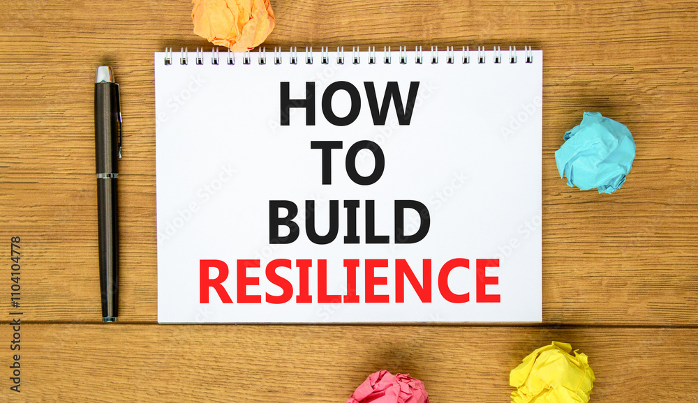 Fototapeta premium How to build resilience symbol. Concept words How to build resilience on beautiful white note. Beautiful wooden background. Black pen. Business and how to build resilience concept. Copy space.
