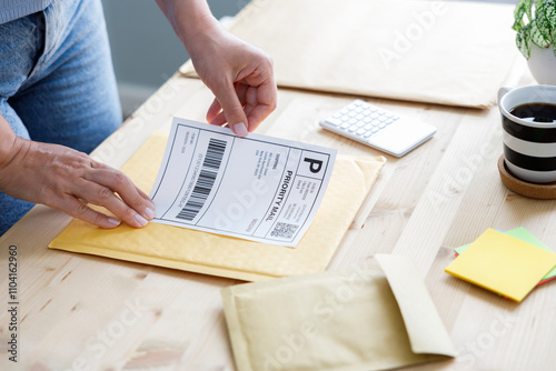 Young entrepreneur packs customer's orders