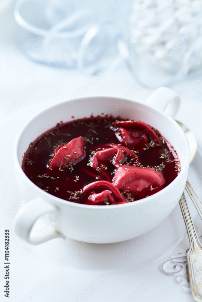Traditional Christmas Borscht (Barszcz) with mushroom dumplings on bright background. Traditional Christmas Borscht (Barszcz) with mushroom dumplings on bright background.