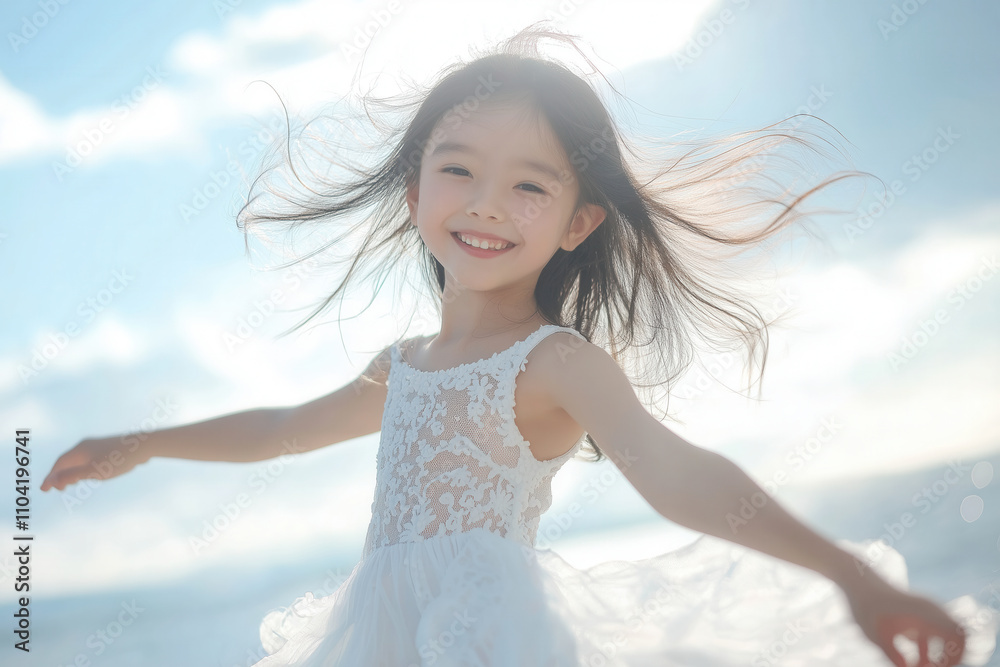 A young Asian girl twirling in a flowy white dress, her hair flying and her smile radiant