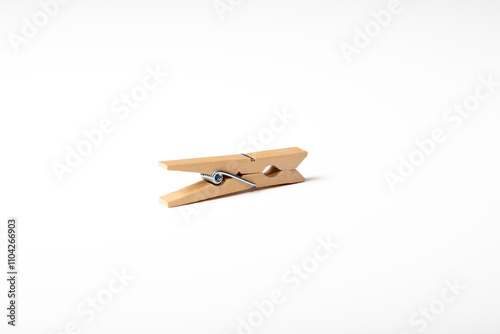 Wooden clothes peg isolated on white background
