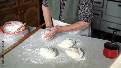 Senior woman making dough balls for baking