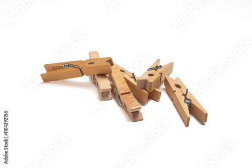 Group of wooden clothes pegs isolated on a white background