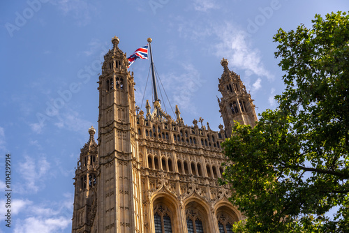 Looking up to London Church lanmark and English Flag with Clear skies