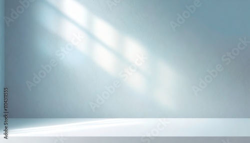 Minimalist light blue abstract background with shadows and soft natural lighting for a product presentation.