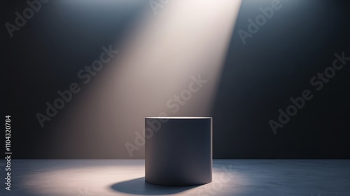 A soft gray pedestal with a light source overhead