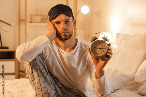Young man in sleeping mask ...