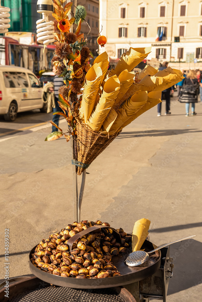 Street trade. Roasted chestnuts on a metal roasting pan