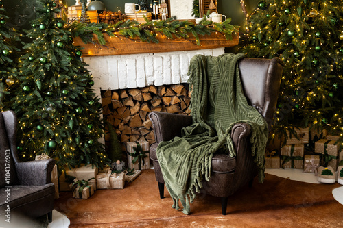 Fireplace room with Christmas decor. Classic armchairs, Christmas tree and fireplace