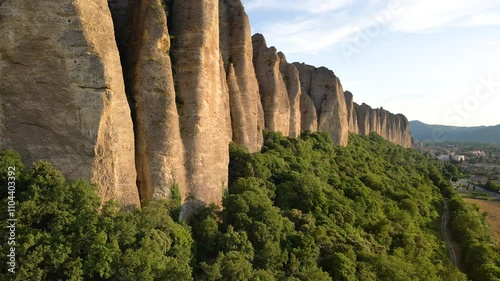 Aerial sunset view of monolith rock formation called Les Pénitents near the village of Les Mées. Alpes-de-Haute-Provence, France