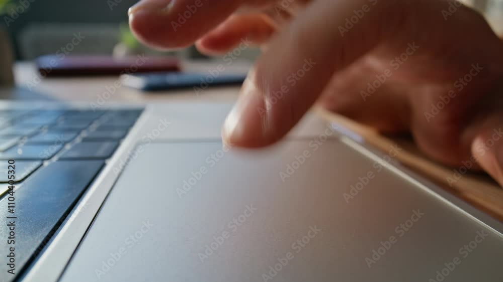 Closeup hand using touchpad laptop in workspace. Macro shot unknown businessman