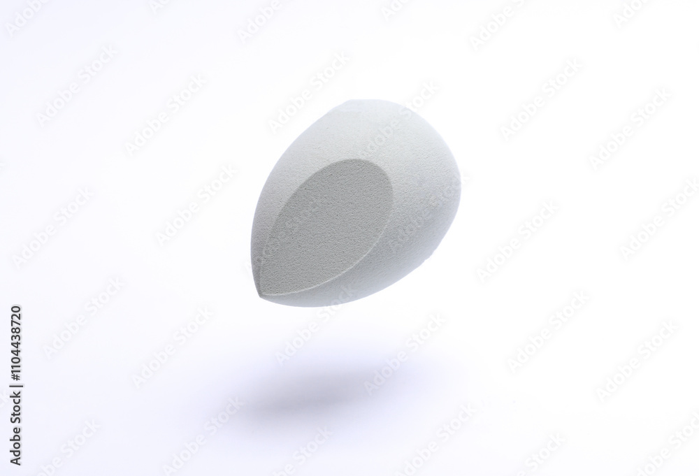 Floating Egg makeup sponge. Blender for foundation on white background. Minimal beauty concept Floating Egg makeup sponge. Blender for foundation on white background. Minimal beauty concept
