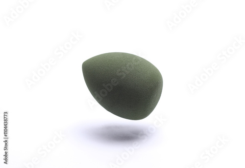 Floating Egg makeup sponge. Blender for foundation on white background. Minimal beauty concept photo